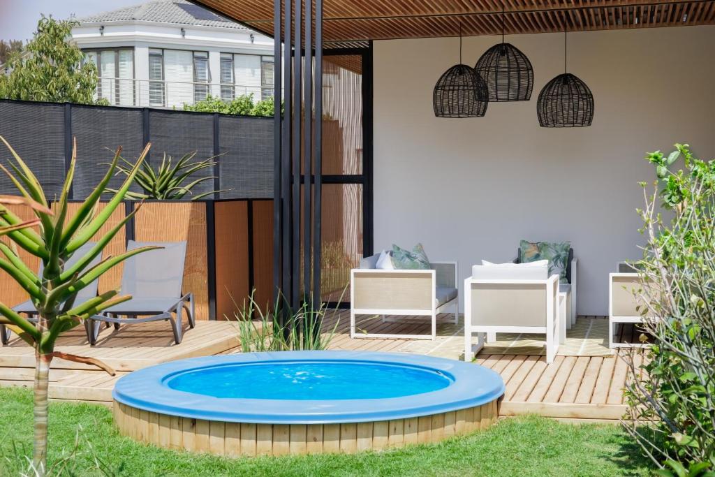 a patio with a blue pool in the middle of a yard at 4 Lulworth in Johannesburg