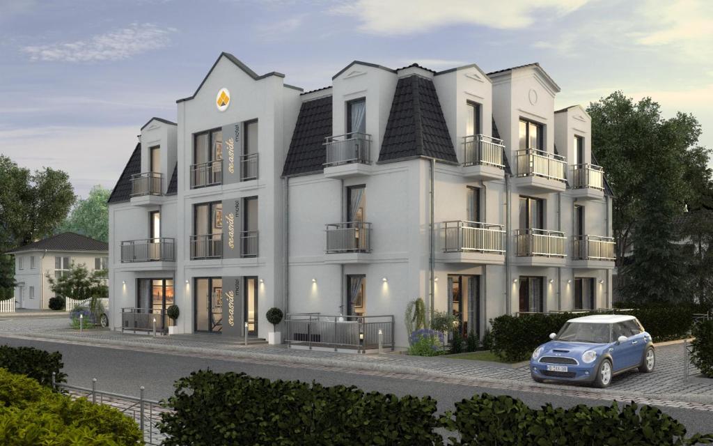 a rendering of a white building with a car parked in front at Bernstein Hotel "50`s Seaside Motel" in Büsum
