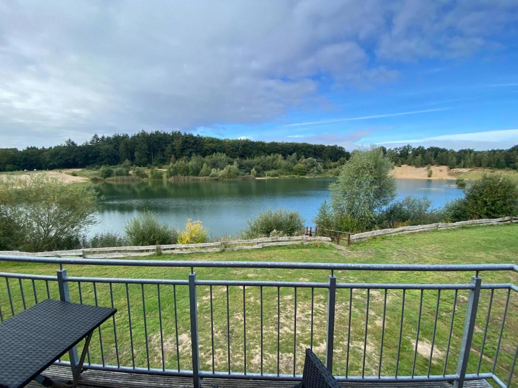 a view of a lake from a balcony at Anglerhaus in Hechthausen in Hechthausen