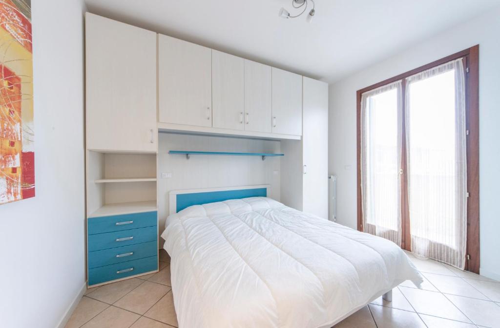 Кровать или кровати в номере Residence Villaggio dei Fiori con Piscina e Posto Spiaggia Incluso