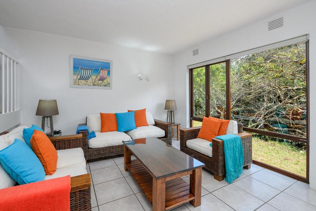 a living room with two couches and a table at San Lameer Villa 3116 - 3 Bedroom Standard - 6 pax - San Lameer Rental Agency in Southbroom