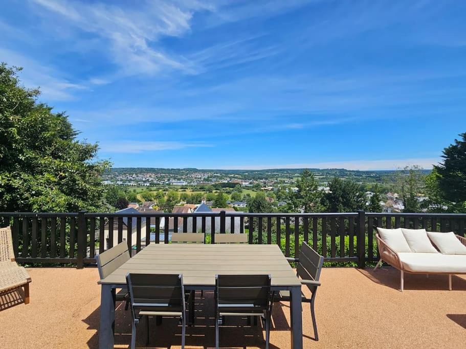 une table et des chaises sur un balcon avec vue dans l'établissement Maison familiale, 8 couchages, cadre exceptionnel, à Deauville