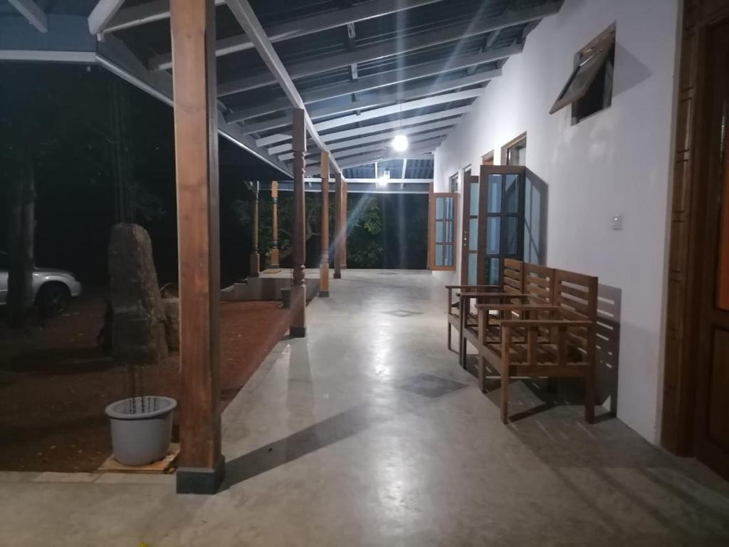 an empty hallway with benches in a building at Kaaya Breeze in Tittawelgolla
