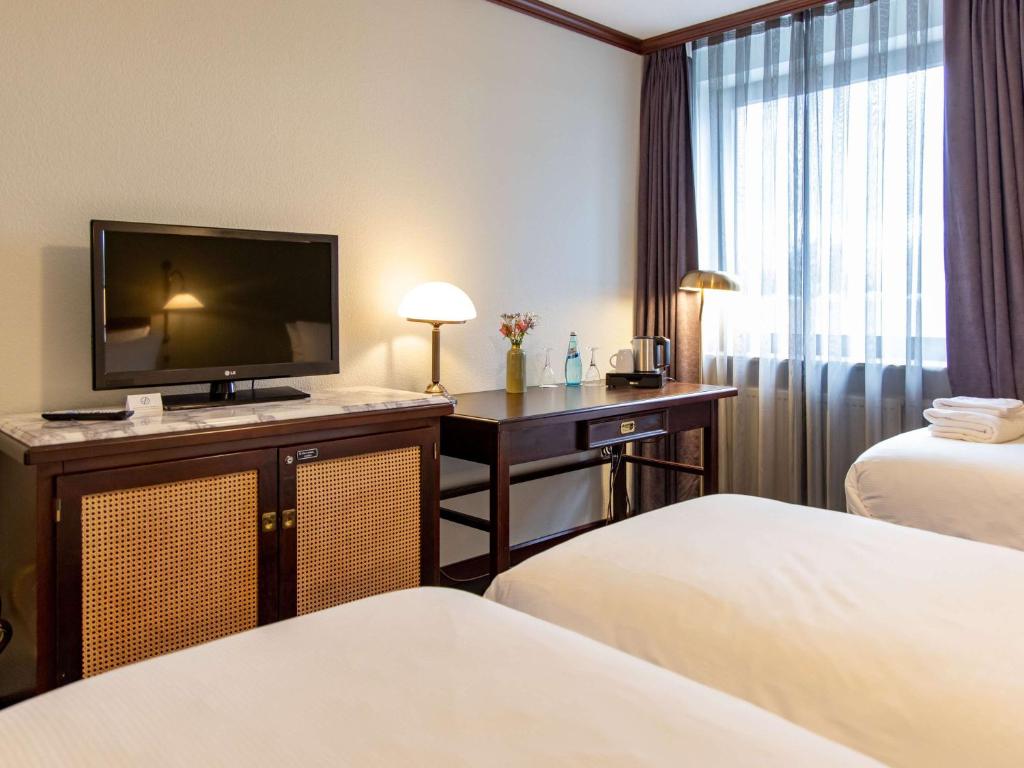 Postel nebo postele na pokoji v ubytování Mercure Hotel Frankfurt Airport Langen