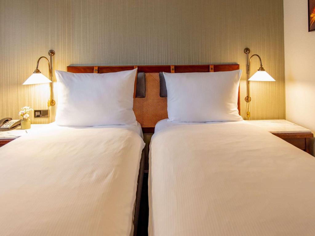 Postel nebo postele na pokoji v ubytování Mercure Hotel Frankfurt Airport Langen