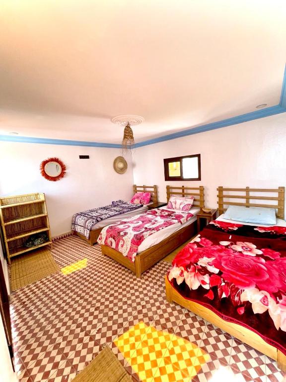 a bedroom with two beds in a room at Binic guest house in Taghazout