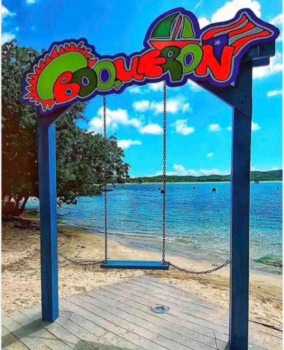 a swing set on a beach with the ocean at Ubicación genial a 3 minutos de combate Beach in El Combate