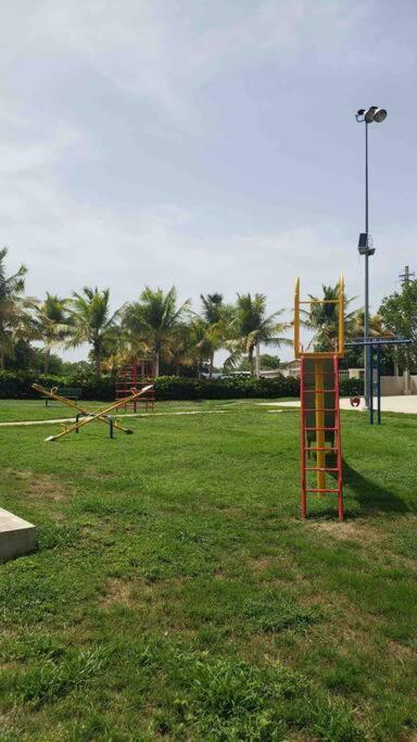 a playground in a park with palm trees at Ubicación genial a 3 minutos de combate Beach in El Combate