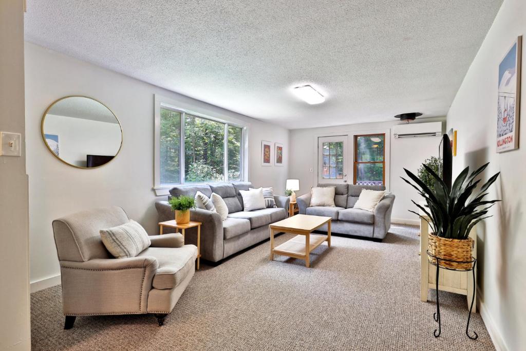 a living room with two couches and a mirror at The Mendon Cottage - Charming Vermont Home Close to Pico, Ski Rental Deals! in Mendon
