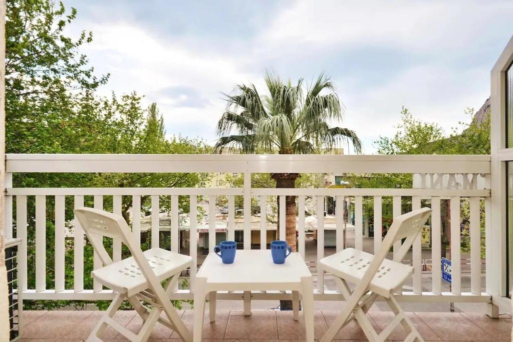 a patio with two chairs and a table at Apartment Toma in Omiš