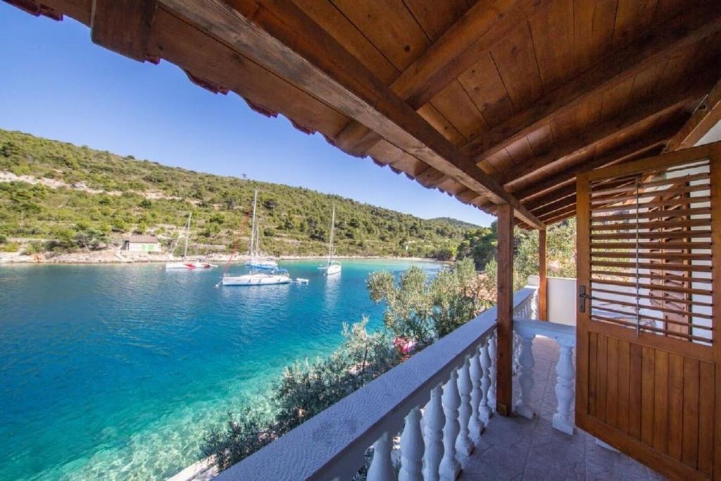 a balcony with a view of a boat in the water at House Vinkli in Kut