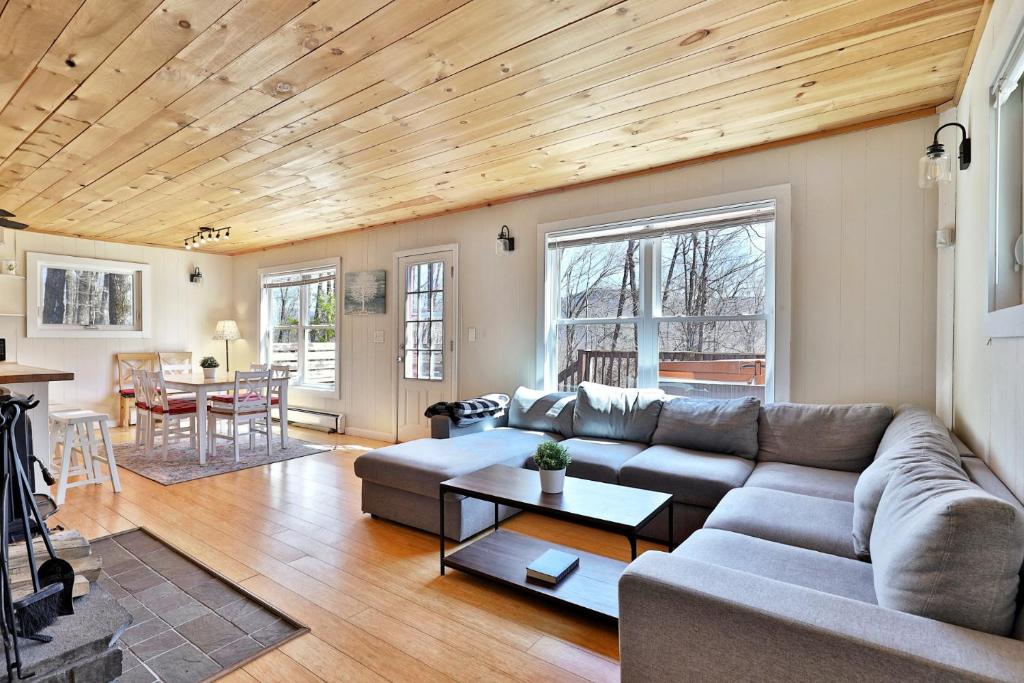 a living room with a couch and a table at Powder Park Place- Upper Unit of Duplex - Great for Groups, Ski Rental Ticket Deals! in Killington