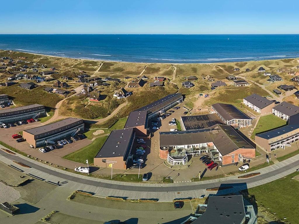 an aerial view of a parking lot next to the ocean at 4 person holiday home in Ringkøbing in Ringkøbing