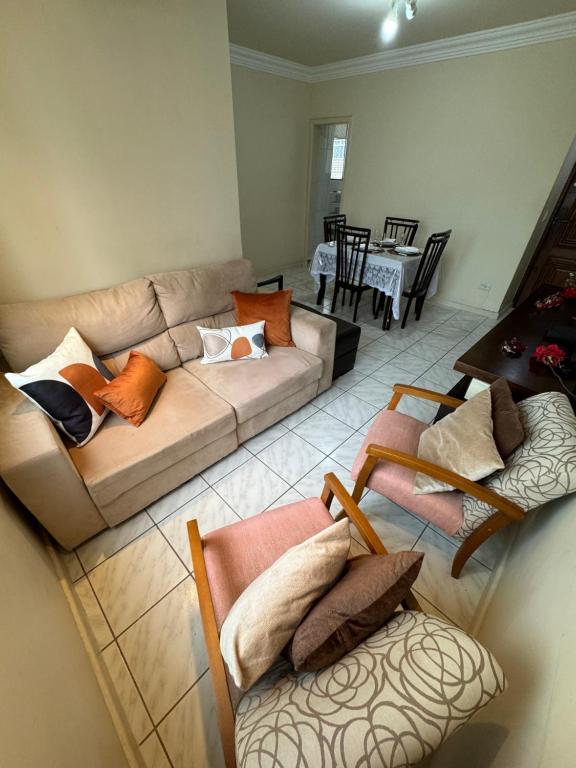 a living room with a couch and a table at Cantinho da Carol - Pituba - Localização Perfeita! in Salvador