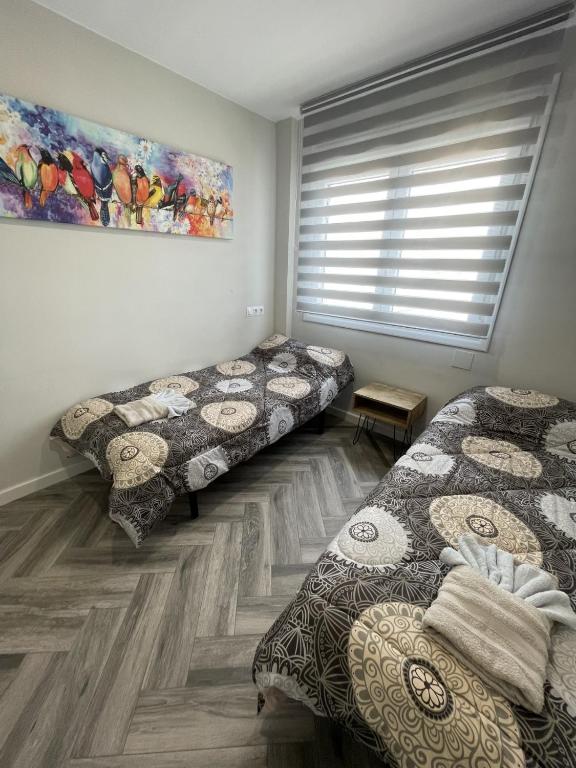 Postel nebo postele na pokoji v ubytování Piso playa Maktub