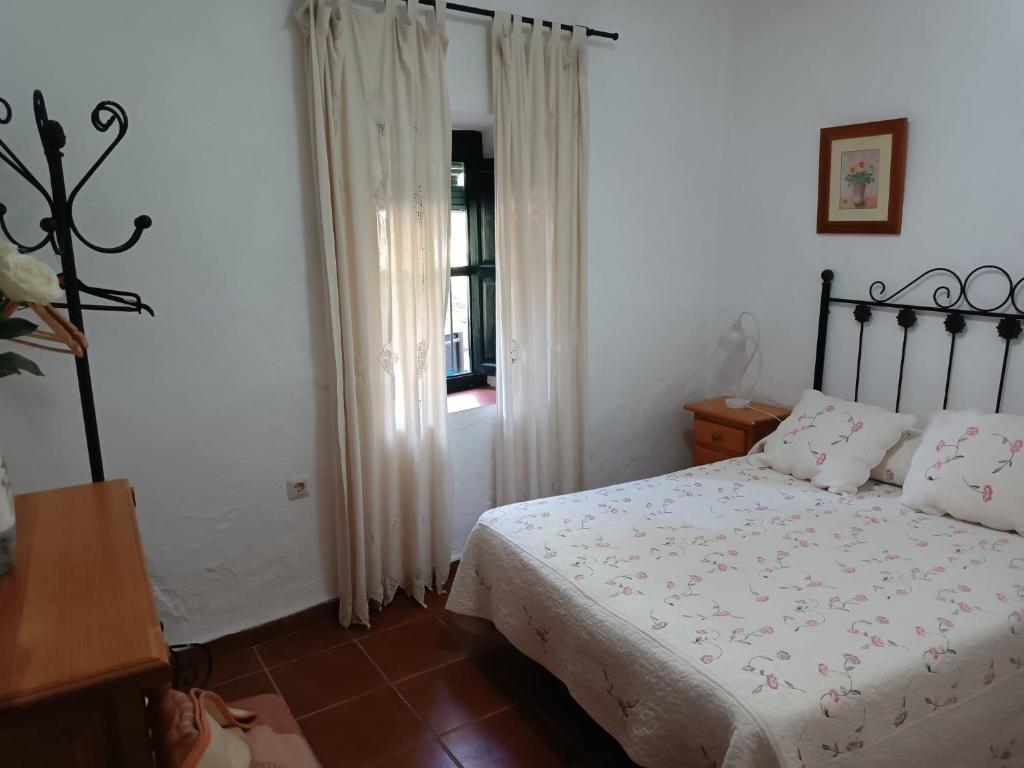 a bedroom with a bed and a window at Huerta Rocio in Linares de la Sierra