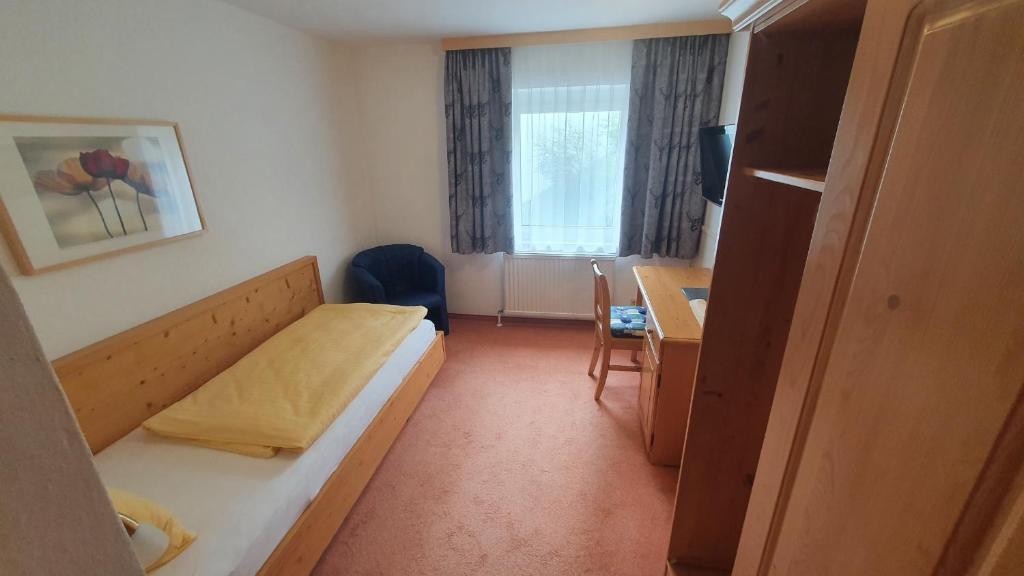 Postel nebo postele na pokoji v ubytování Hotel Garni Dorfblick