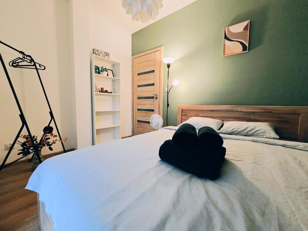 a bedroom with a bed with a black heart on it at ApartStars Powstańców #17 in Rzeszów