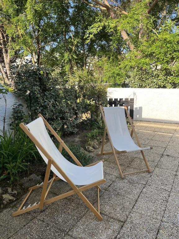 - deux chaises assises l'une à côté de l'autre sur une terrasse dans l'établissement Les Piimprenelles, à Saint-Jean-de-Monts