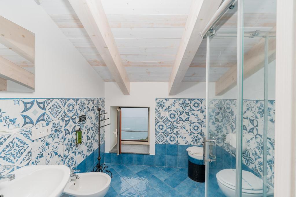 a bathroom with two sinks and a shower at Albergo Diffuso Bacco Furore in Furore