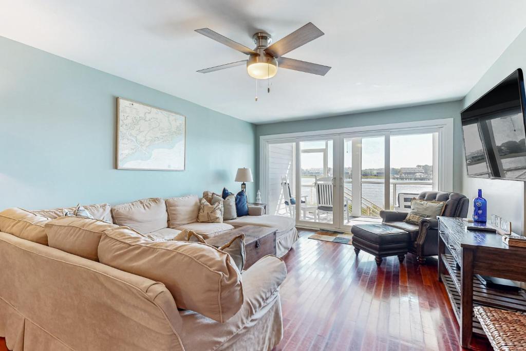 a living room with a couch and a ceiling fan at Mariners Cay 40 in Folly Beach