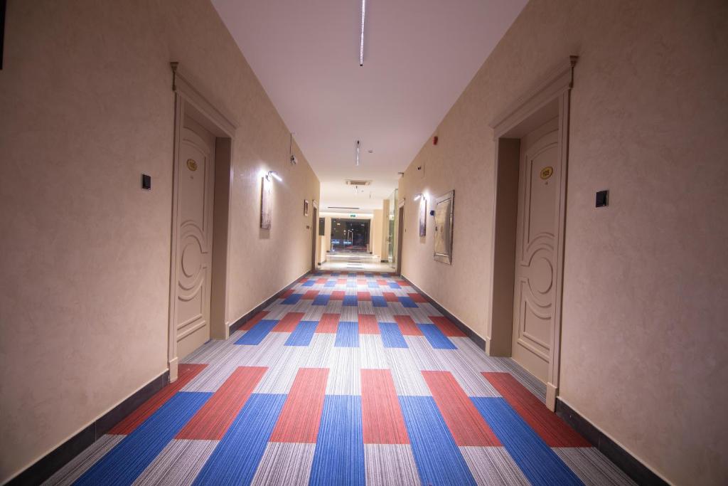 an empty hallway with colorful floors in a building at Towlan Alfalah in Riyadh