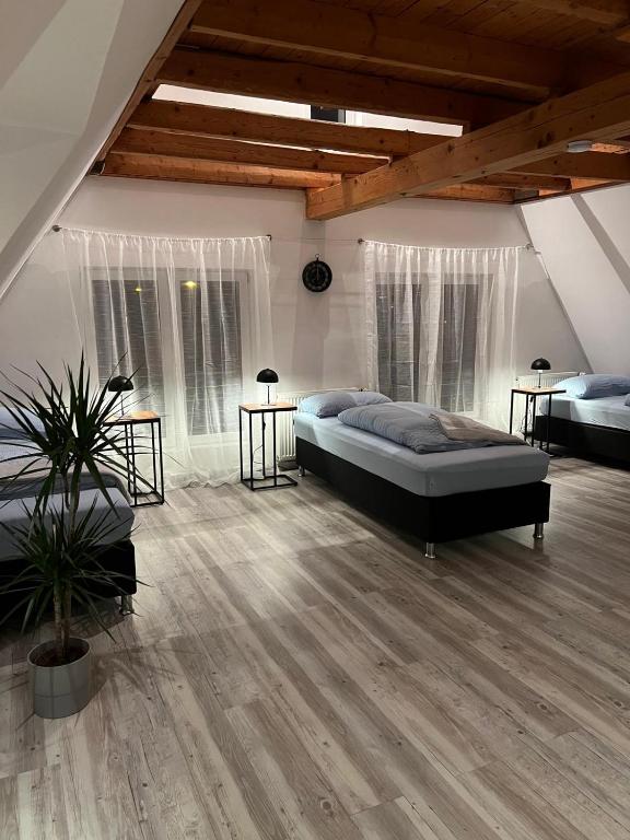 a large room with two beds and two windows at Ferien- Monteurwohnung in Bielefeld