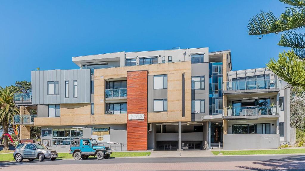 an apartment building with a blue truck parked in front of it at 9/4 The Esplanade, Cowes - Cscape in Cowes