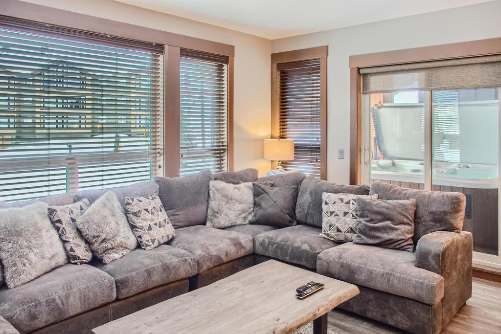 a living room with a couch and a table at Stonegate Resort Unit B103 in Big White