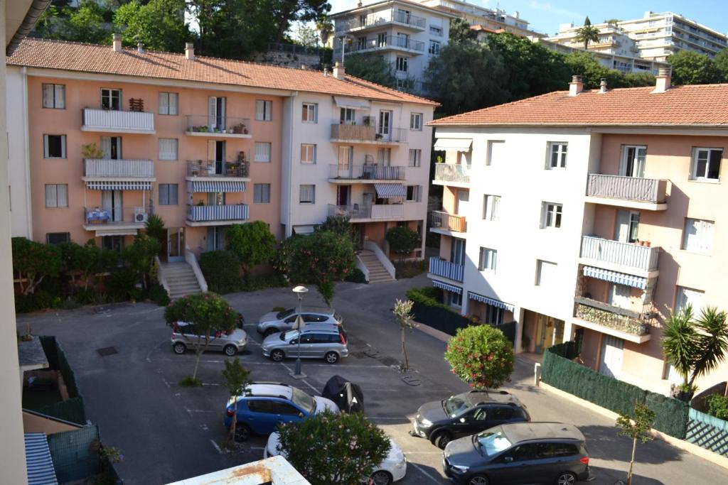 un complexe d'appartements avec des voitures garées dans un parking dans l'établissement Spacieux/paisible 5 pièces en plein coeur de Nice, à Nice
