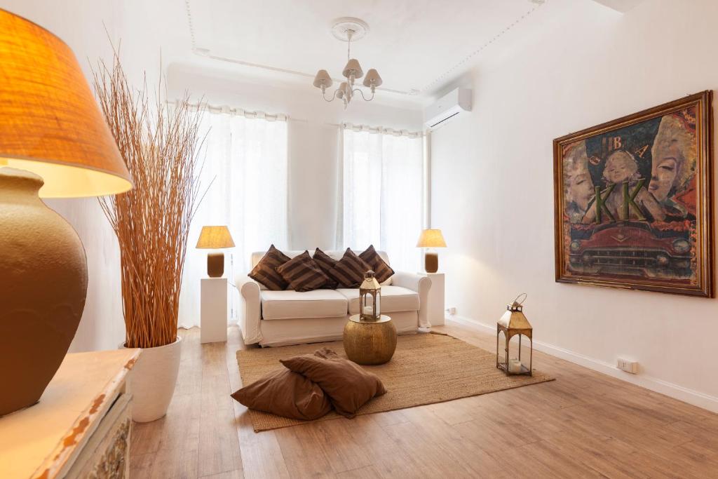 a living room with a couch and a painting on the wall at Piazza di Spagna Historic Flat in Rome