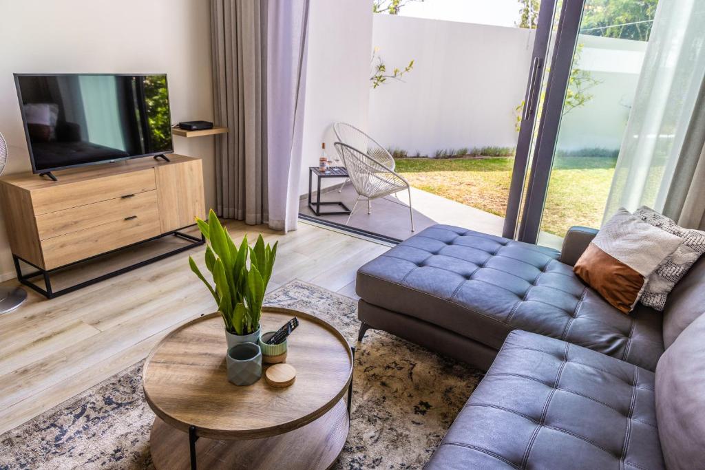 a living room with a couch and a tv at 4 Lulworth in Johannesburg