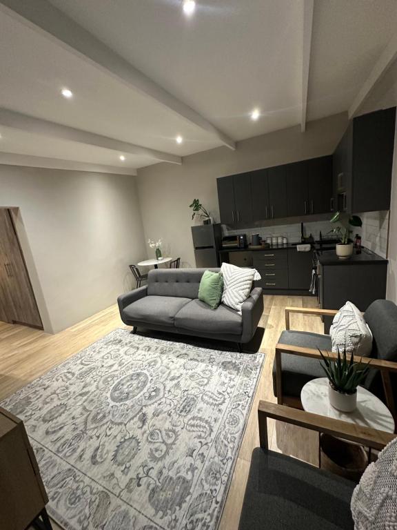 a living room with a couch and a rug at Somerset-West PRIME SPOT- Solar Powered! in Cape Town