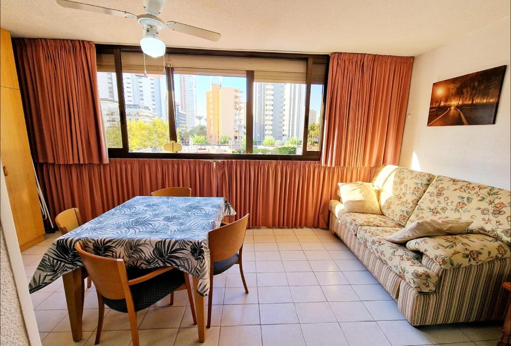 a living room with a table and a couch at Gemelos2 Benidorm Rincon de loix in Benidorm