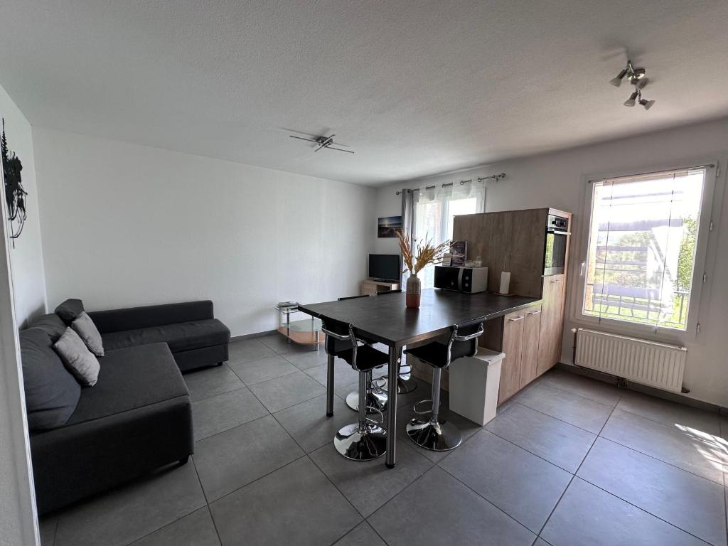 un salon avec une table et un canapé dans l'établissement Hameau de tranquillité, à Gap