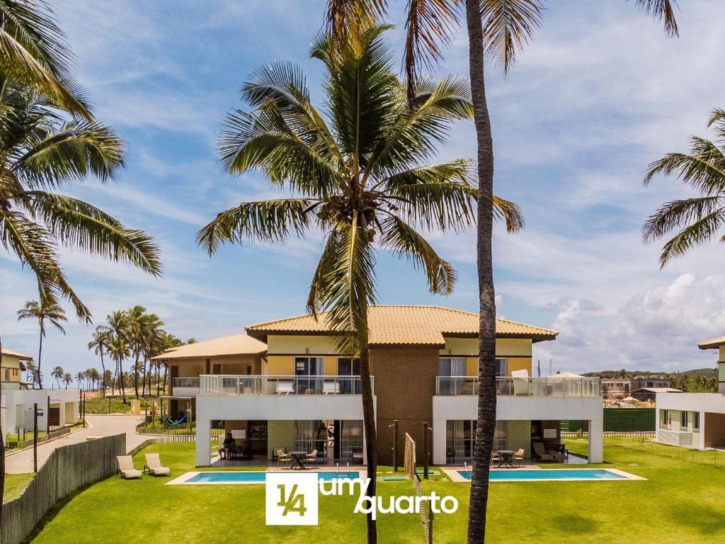 a view of a villa with palm trees at Ponta de Inhambupe Residences in Esplanada