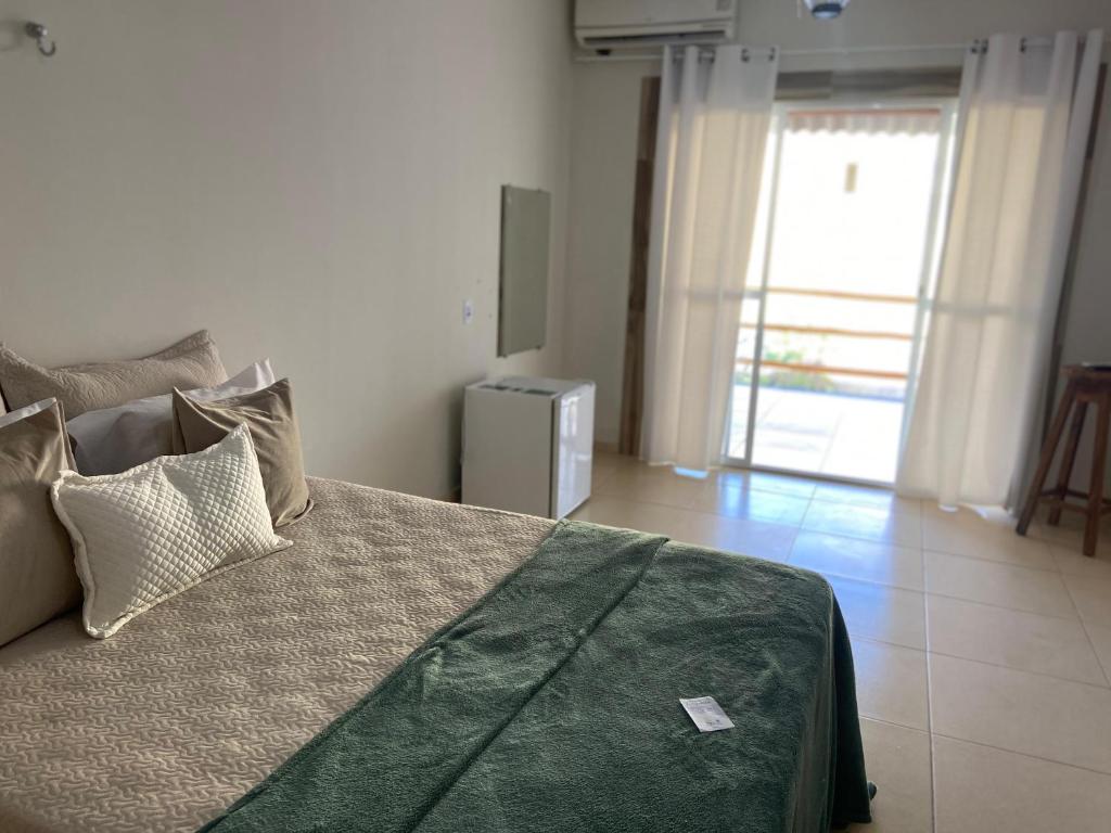 Ένα ή περισσότερα κρεβάτια σε δωμάτιο στο Pousada Villa Coqueirais