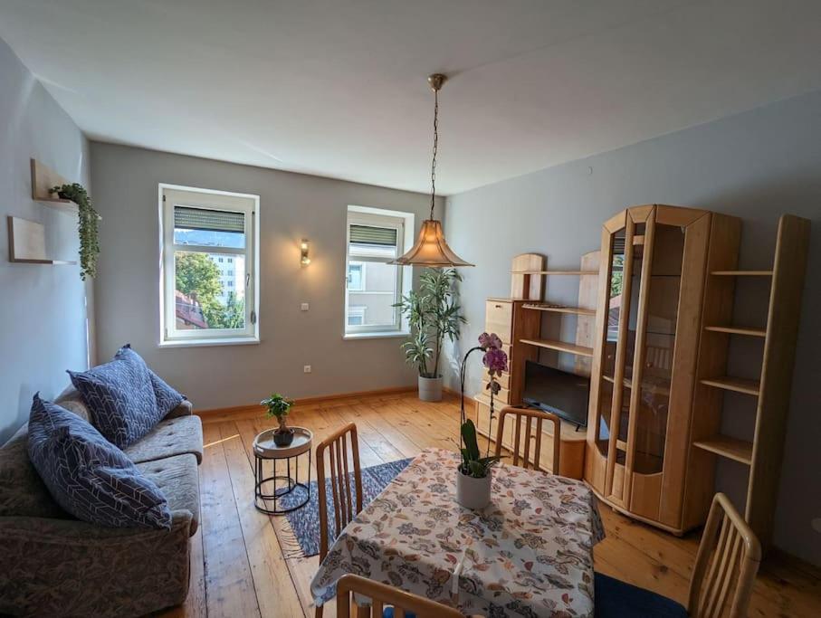 a living room with a couch and a table at Spacious Room in Tyrolean Flat in Innsbruck