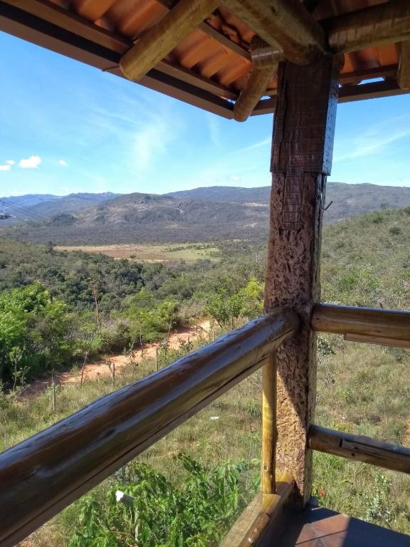 a view from the porch of a house with mountains in the background at Pousada Cachoeiras do Cipó in Serra do Cipo