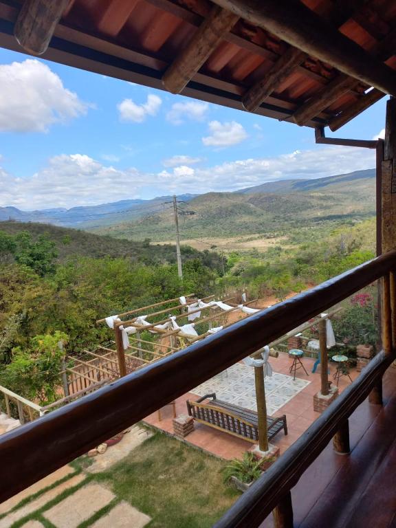 a view of the mountains from the balcony of a house at Pousada Cachoeiras do Cipó in Serra do Cipo