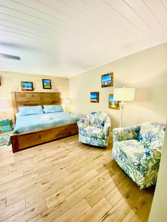 a bedroom with a bed and a chair at Oak Cottages 4 in Rockport