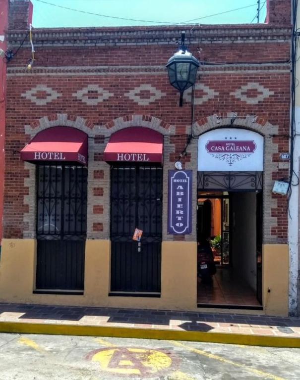 a brick building with two entrances to a hotel at Hotel Casa Galena in Morelia