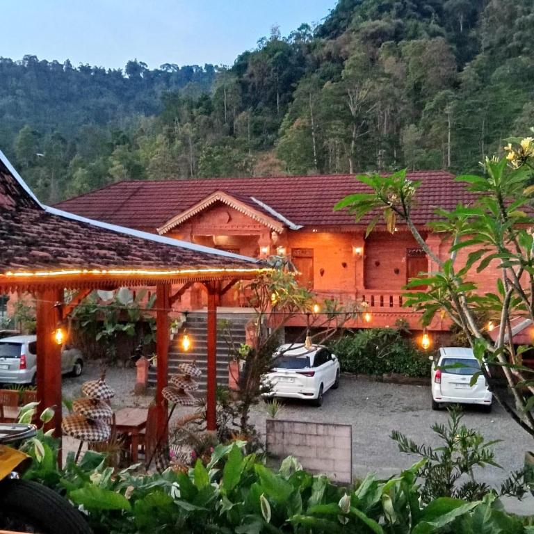 a house with cars parked in front of it at VILLA PRINGGITAN in Karanganyar