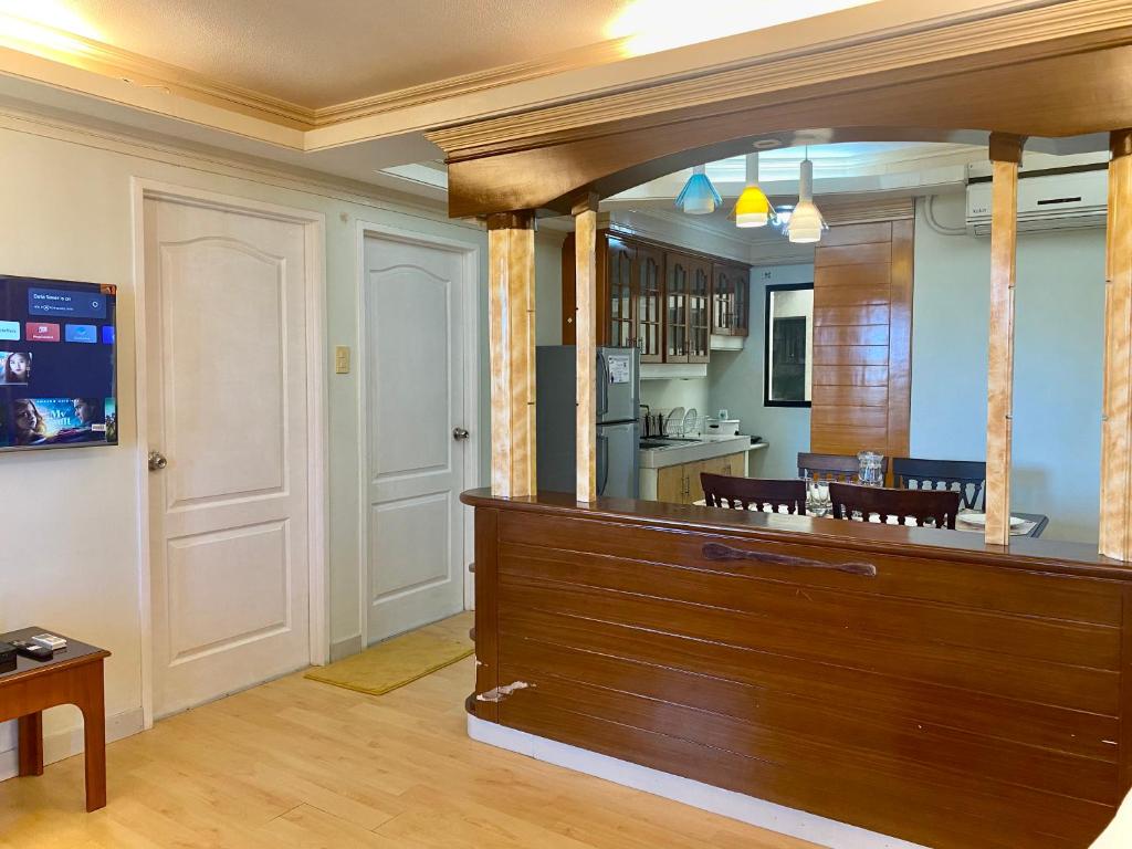 a kitchen with a large wooden counter in a room at Budget Family 2BR Fast Wifi Free Pool beside SM Mall in Davao City