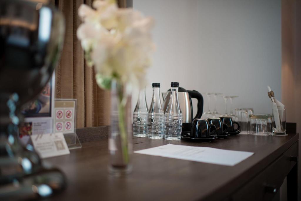 a vase filled with flowers sitting on a counter at The Berkeley Hotel Pratunam in Bangkok