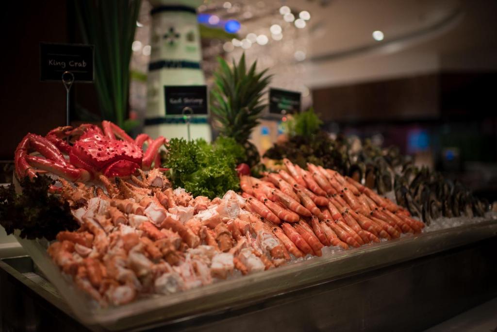 a display of meat and vegetables on a counter at The Berkeley Hotel Pratunam in Bangkok