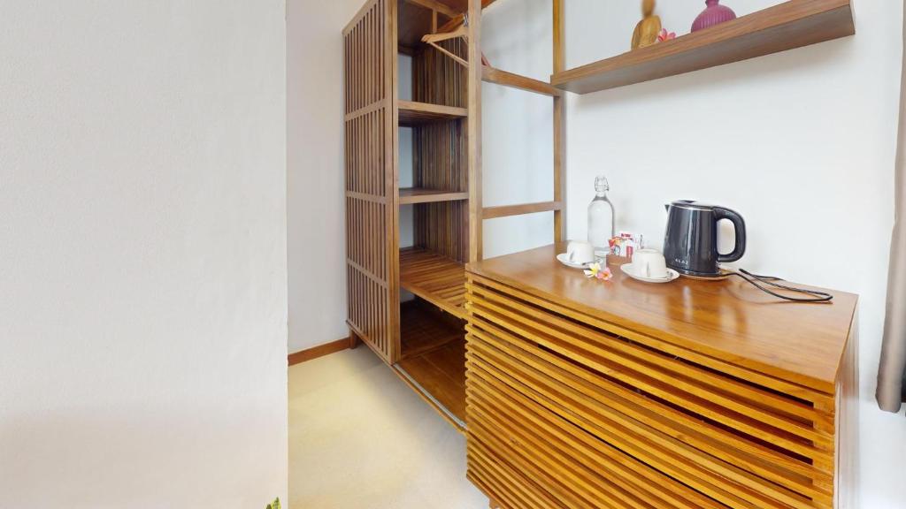a kitchen with a wooden counter top in a room at Segara Seaside Resort in Nusa Lembongan