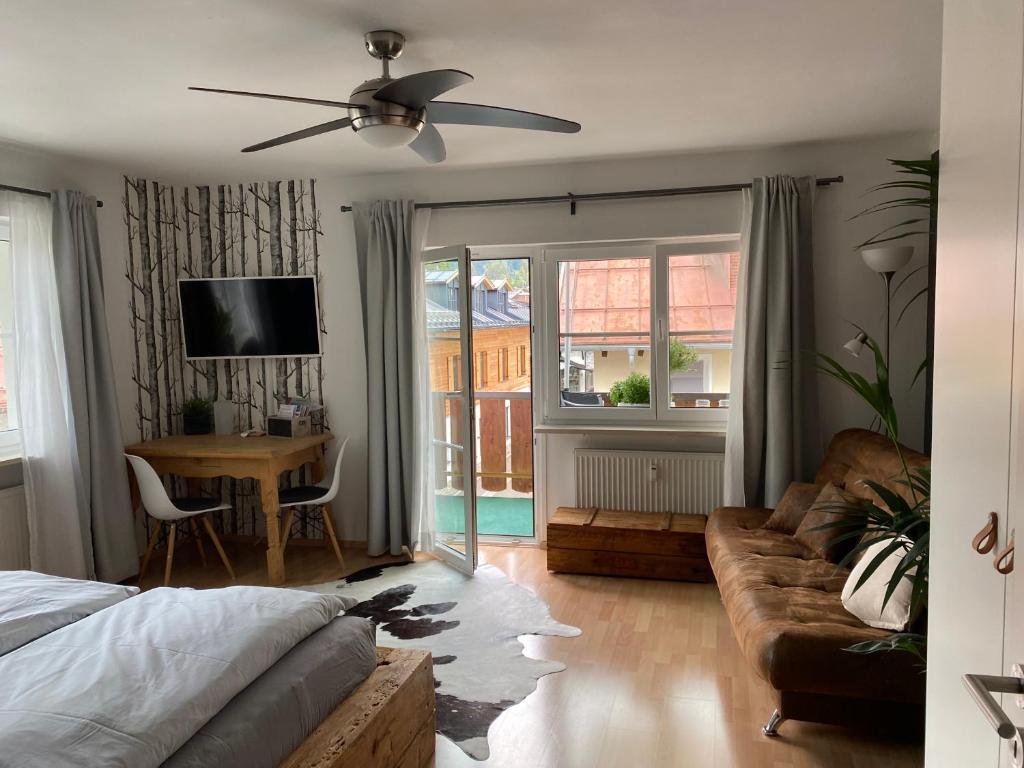 a bedroom with a bed and a couch and a table at Ferienwohnung im Herzen von Oberstdorf in Oberstdorf