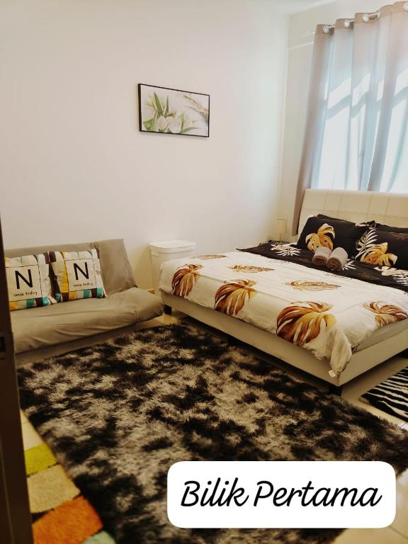 a bedroom with a bed and a couch at Meeymohd Homestay in Ipoh