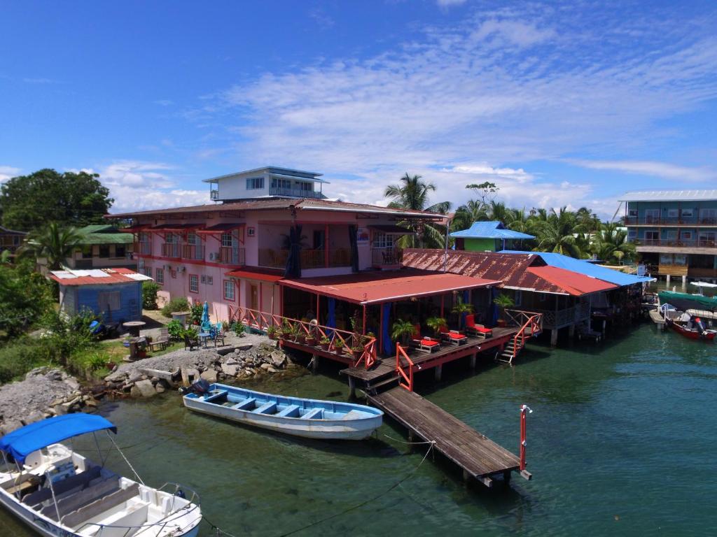 a boat is docked next to a building on the water at Vista Mar Hotel  in Bocas Town